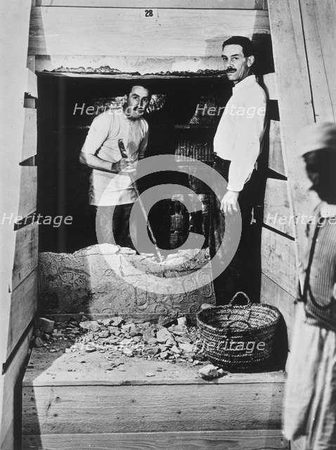 Howard Carter and a colleague excavating a tomb in the Valley of the Kings, Egypt, 1922. Artist: Harry Burton