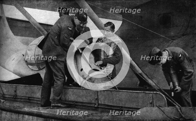 Loading bombs on to an RAF aircraft during World War II, c1940 (1943). Artist: Unknown.