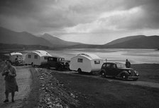 Group of cars and caravans camping in Scottish Highlands 1930's. Creator: Unknown.