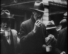 Three Men in the Foreground Drinking and Eating, 1933. Creator: British Pathe Ltd.