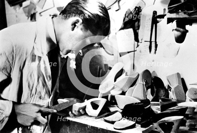 Making wooden shoe soles, German-occupied Paris, February 1941. Artist: Unknown