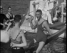 Two Male Civilians in Swim Suits Sitting on a Pole and Enjoying a Pillow Fight in Front..., 1931. Creator: British Pathe Ltd.