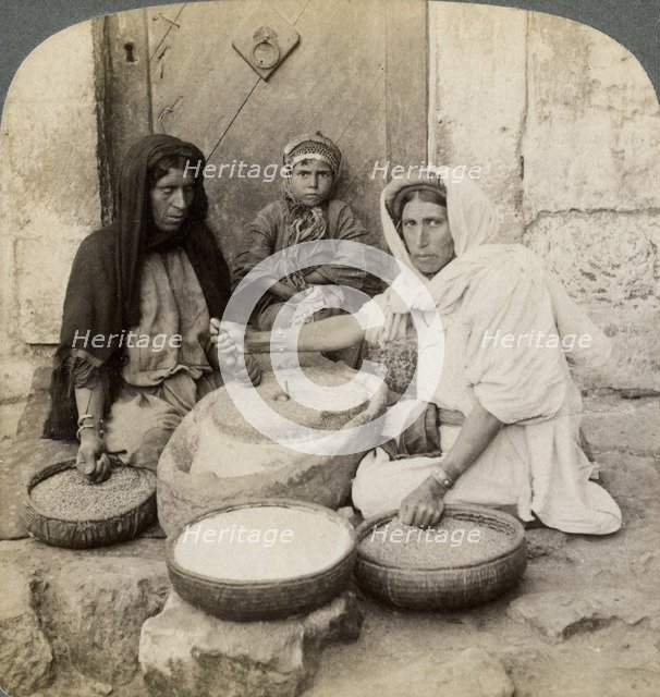 Women grinding at the mill, Palestine, 1900.Artist: Underwood & Underwood