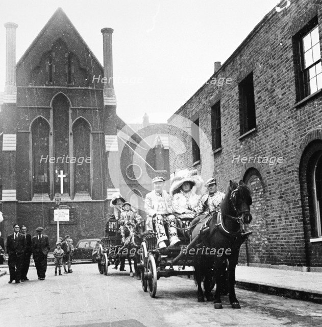 Pearly king and queen riding through London in a carriage, c1950s. Artist: Unknown