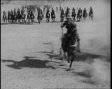 Scene from a Film: Actors Playing British Troops on Horseback Speeding Across a Desert..., 1920s. Creator: British Pathe Ltd.