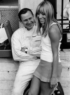 Bruce McLaren with female admirer in the pits, 1967 Italian Grand Prix. Creator: Unknown.