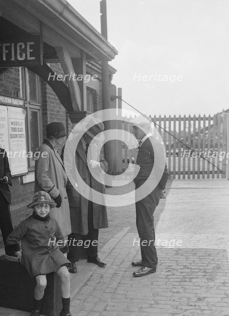 Group of people outside a Metropolitan Line railway station, London, 1930s.   Artist: Bill Brunell.