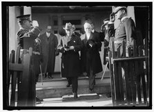 Woodrow Wilson descending steps with unidentified persons, between 1910 and 1917. Creator: Harris & Ewing.