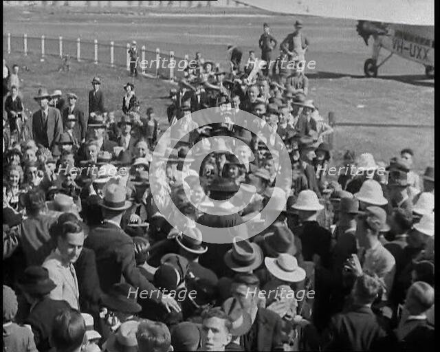 Jean Batten Walking Through a Crowd, 1930s. Creator: British Pathe Ltd.
