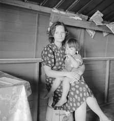 Mother with sick baby awaits arrival of FSA camp resident nurse, FSA camp, Tulare County, CA, 1939. Creator: Dorothea Lange.