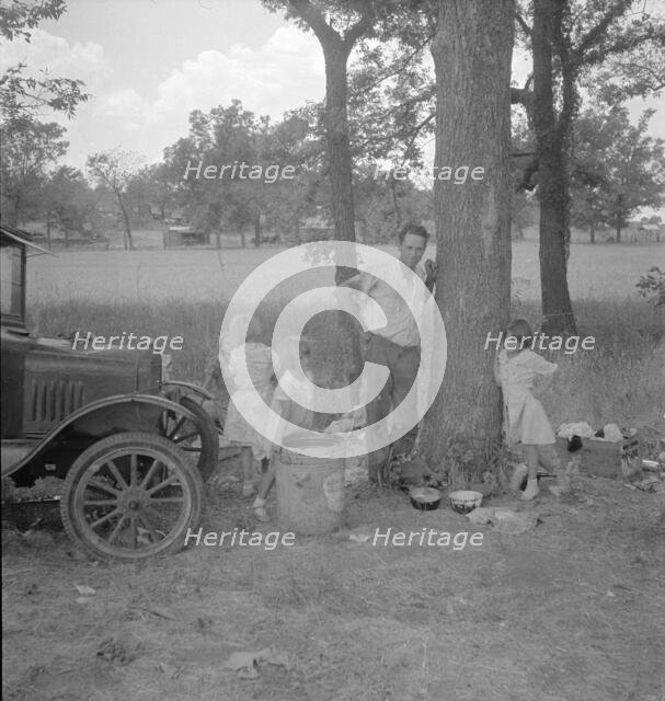 Migrant family from Oklahoma in Texas, alongside the road, 1936. Creator: Dorothea Lange.