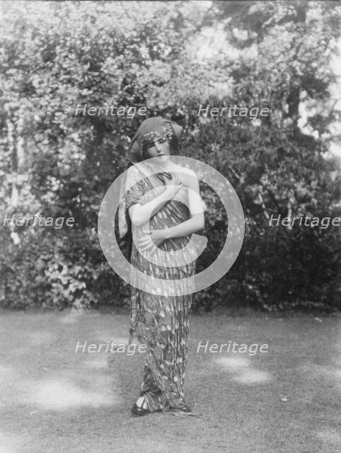 Person wearing a mask made by W.T. Benda, 1925 Sept. 20. Creator: Arnold Genthe.
