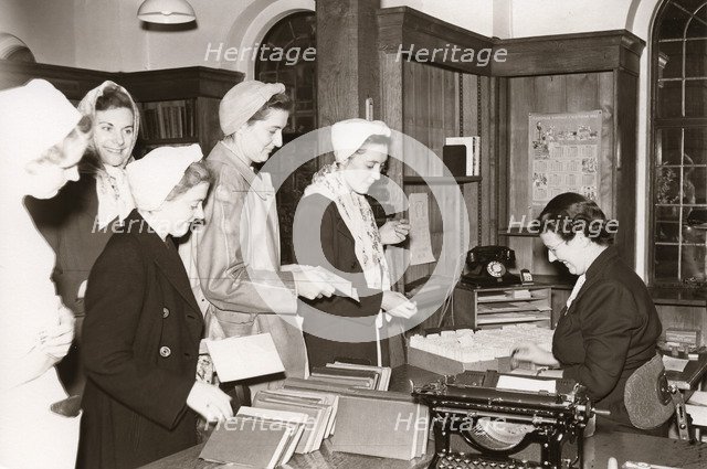 Women employees in to the library, Rowntree factory, Yorkshire, 1952. Artist: Unknown