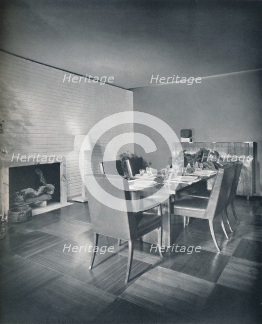 'Dining-room furniture with leather-upholstered chairs designed by T. H. Robsjohn-Gibbings and made  Artist: Unknown.