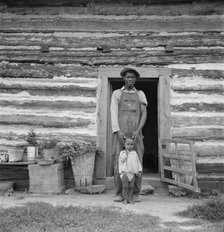 Young sharecropper and his first child, Hillside Farm, Person County, North Carolina, 1939. Creator: Dorothea Lange.