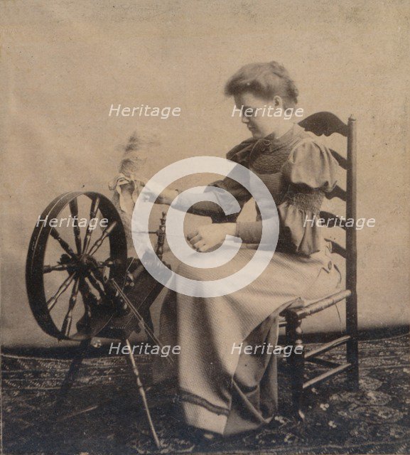 A lady at a spinning wheel c1900. Artist: Unknown