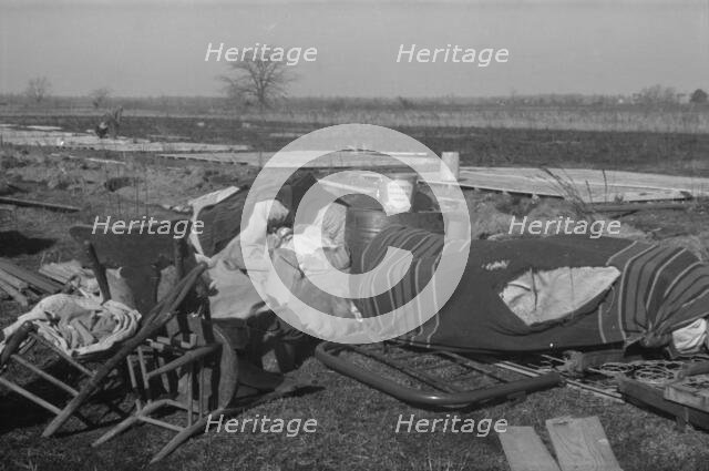 Possibly: Setting up a tent in the camp for white flood refugees, Forrest City, Arkansas, 1937. Creator: Walker Evans.