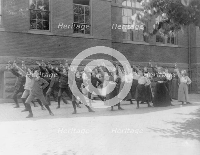 First Division school class exercising with barbells in schoolyard, Washington, D.C., (1899?). Creator: Frances Benjamin Johnston.