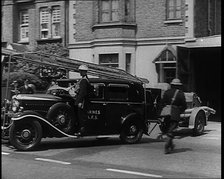 A Car With a Fire Hose attached Driving Away, 1940. Creator: British Pathe Ltd.