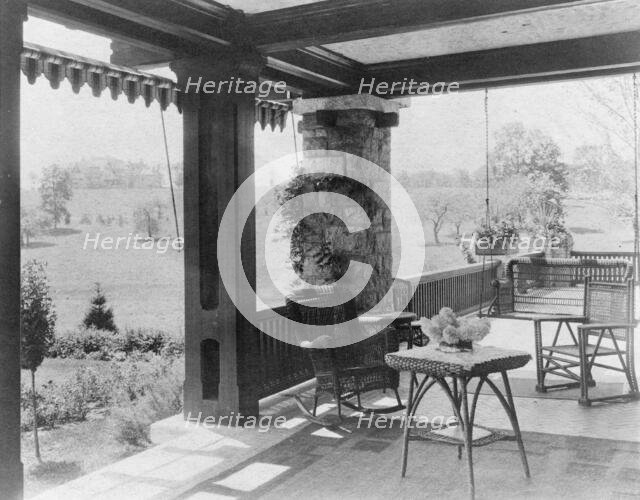 Porch with wicker furniture, and view over lawn to home of Edmund..., Greenwich, Connecticut, 1908. Creator: Frances Benjamin Johnston.