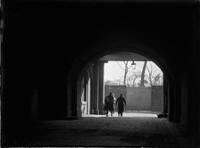 Tunnel or covered passage looking towards three figures, Greater London Authority, 1930s. Creator: Charles William  Prickett.