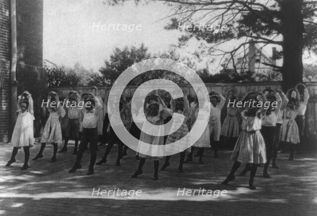 School children learning a dance in a school yard, Washington, D.C., (1899?). Creator: Frances Benjamin Johnston.