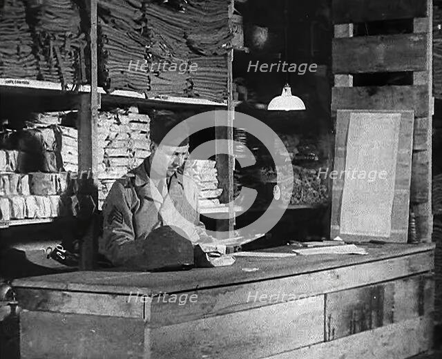 An American Store Keeper Logging Stocks of Supplies at a Storage Facility in an..., 1943-1944. Creator: British Pathe Ltd.