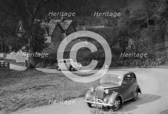 Vauxhall 10 of Miss IM Burton amd Rover of CG Dunham competing in the RAC Rally, 1939. Artist: Bill Brunell.