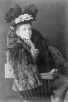 Frances Benjamin Johnston, 1864-1952, half length, seated, facing right, wearing fur jack..., 1890s. Creator: Frances Benjamin Johnston.