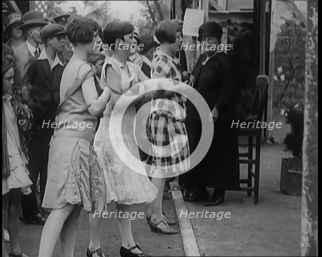 Female Children Throwing Balls at a Coconut Shy, 1926. Creator: British Pathe Ltd.