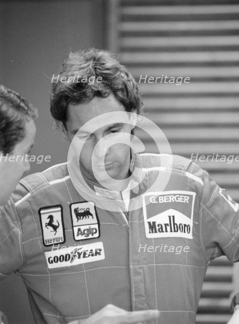 Gehard Berger listening to a member of the Ferrari team, 1988. Artist: Unknown