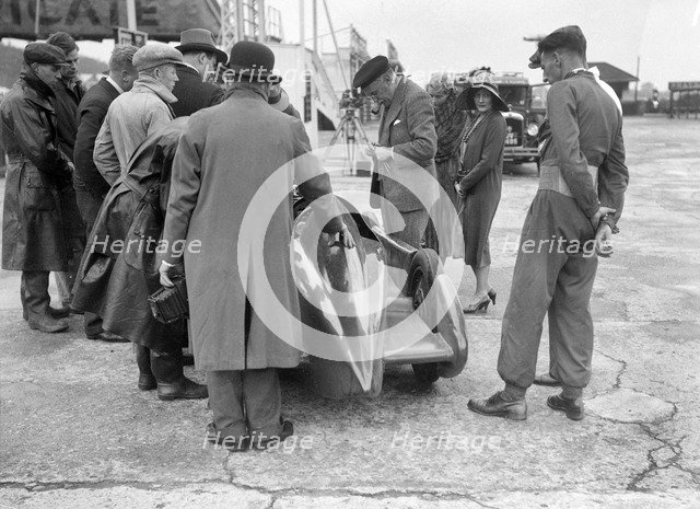 People examining Leon Cushman's Austin 7 racer at Brooklands for a speed record attempt, 1931. Artist: Bill Brunell.