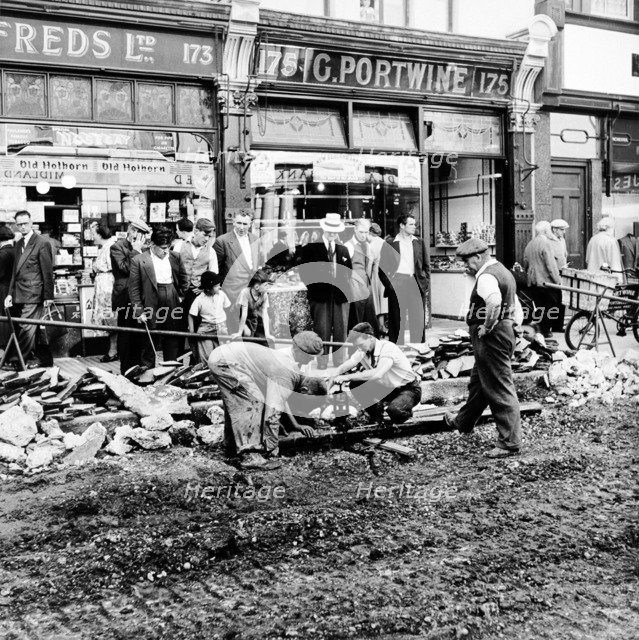 Road repairs in Portobello Road, London, c1956. Artist: Henry Grant