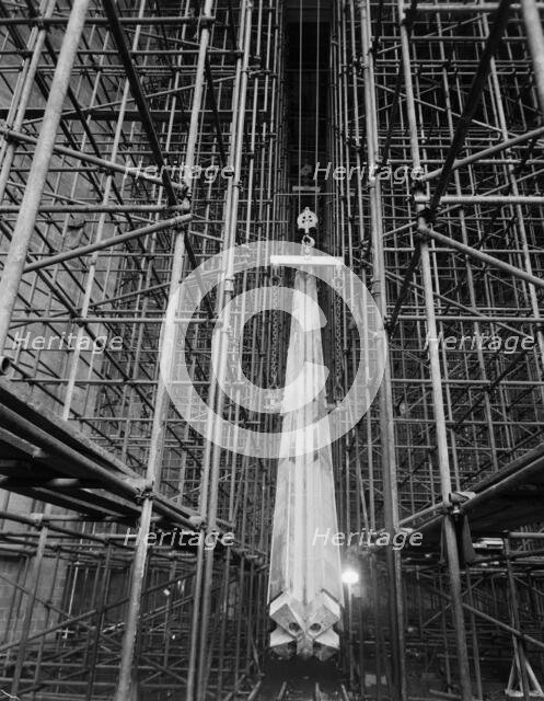 A nave column being hoisted into position during the construction of Coventry Cathedral, 1959.  Creator: John Laing plc.