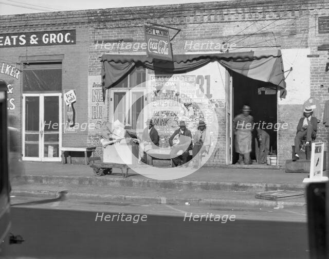 Sidewalk scene in Selma, Alabama, 1935. Creator: Walker Evans.
