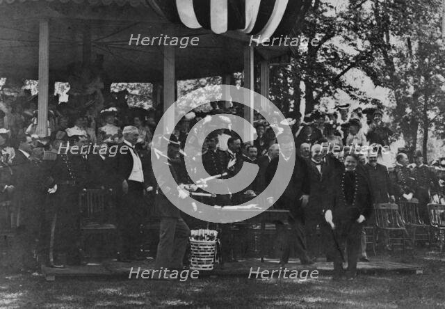 Graduation Day at Annapolis - cadet receiving his diploma from President Theodore Roosevelt, 1902. Creator: Frances Benjamin Johnston.