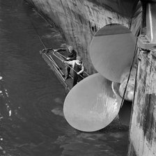 Cleaning the propellor of a ship, London Docks, September 1965. Artist: John Gay