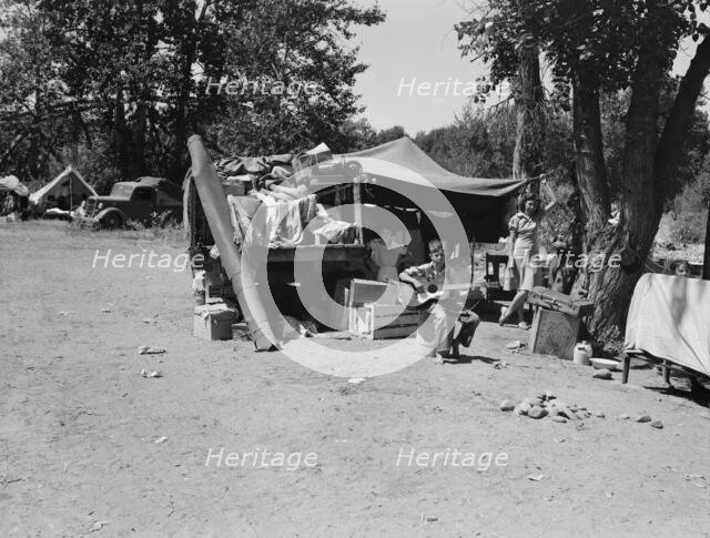 Camp of family with nine children...on the road for three years, Washington, Yakima Valley, 1939. Creator: Dorothea Lange.