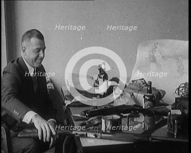 Male Detective Showing off Smugglers' Captured Guns, 1929.  Creator: British Pathe Ltd.