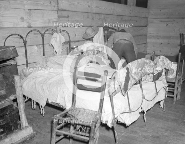 Sick Negro in the Red Cross temporary infirmary for flood refugees, Forrest City, Arkansas, 1937. Creator: Walker Evans.