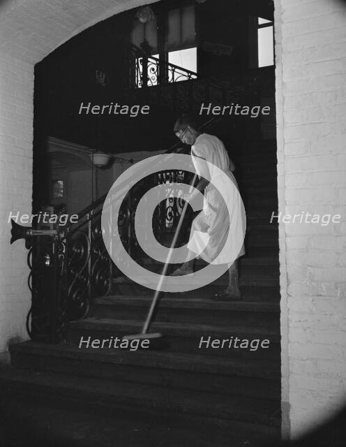 Government charwoman cleaning after regular working hours, Washington, D.C., 1942. Creator: Gordon Parks.