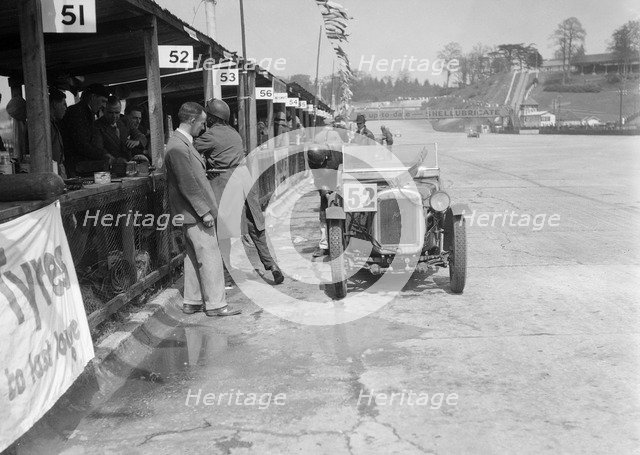 Austin Ulster of ECH Randall and WE Harker in the pits, JCC Double Twelve race, Brooklands, 1931. Artist: Bill Brunell.