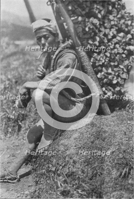 'Middle-aged coolie hurriedly seated himself on the bank to pass us in review', c1900, (1921). Artist: Julian Leonard Street.