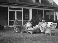 Sexton, Mr. and Mrs., and an unidentified man, seated outdoors, between 1932 and 1936. Creator: Arnold Genthe.