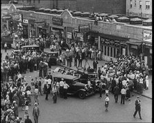 Crowded New York City Street Where Police and Ambulance Attend to Dead and Dying Victims..., 1932. Creator: British Pathe Ltd.