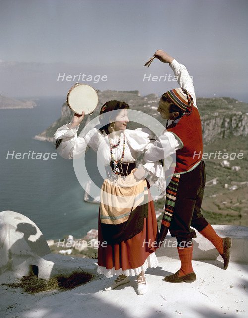 Dancers perform a tarantella above the Bay of Naples, Isle of Capri, Italy, 1948. Artist: Göran Algård