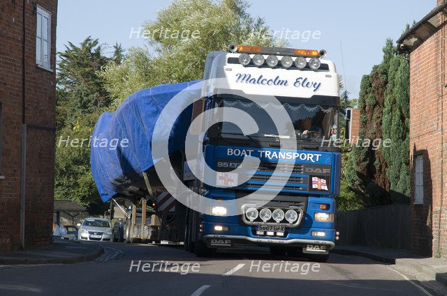 DAF 95 XF wide load truck carrying a life boat through a small village