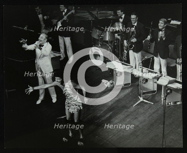 Joe Loss (left) on stage with his orchestra at the Forum Theatre, Hatfield, Hertfordshire, 1986. Artist: Denis Williams