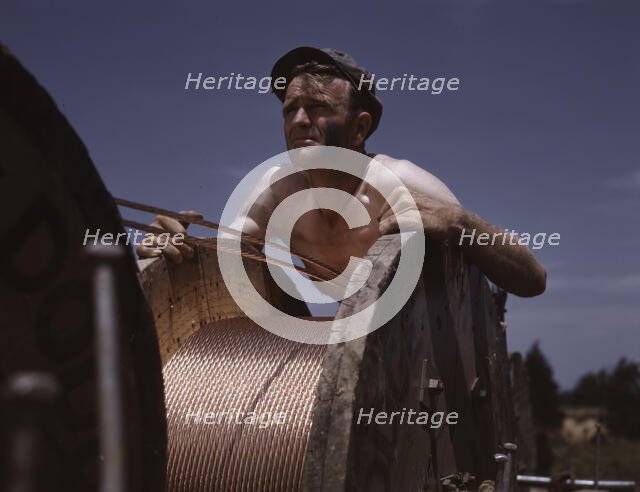 This husky member of a construction crew building a new 33,000-volt electric..., Ft. Knox, Ky., 1942 Creator: Alfred T Palmer.