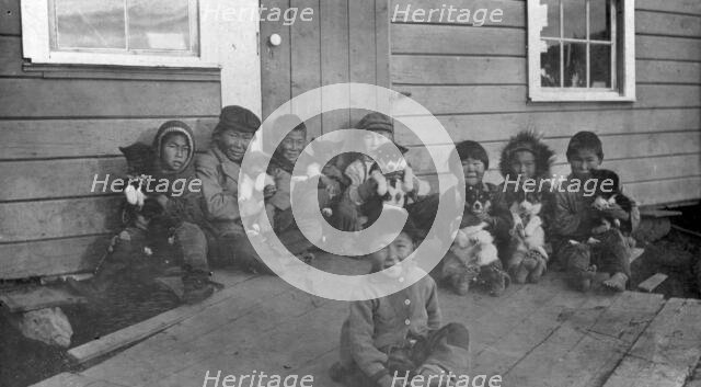Eskimo children and puppies at the Moravian Mission Station, between c1900 and c1930. Creator: Unknown.